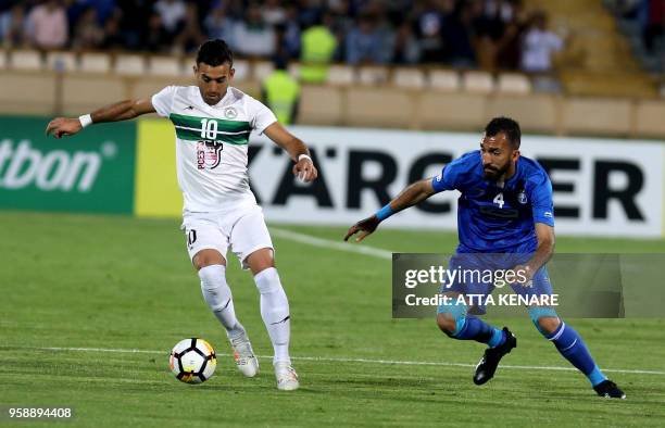 Iranian Esteghlal FC club player Roozbeh Cheshmi and Iranian Zobahan FC club player Bakhtiar Rahmani vies for the ball during their AFC Champions...