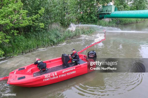 Firefighters supervising the process of draining sewage are seen in Gdansk, Poland on 15 May 2018 Over 50 milion untreated sewage is pumped directly...