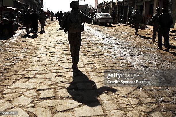 Member of a US Army Provincial Reconstruction Team walks down the street on January 20, 2010 in Orgune, Afghanistan. The soldiers, from Forward...