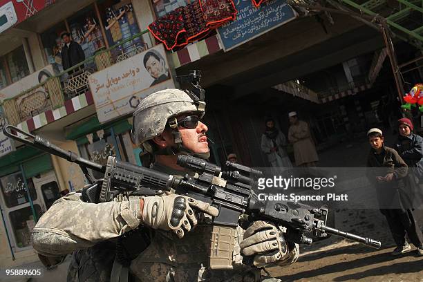 Sgt. Francisco Espinoza with a US Army Provincial Reconstruction Team walks down the street on January 20, 2010 in Orgune, Afghanistan. The soldiers,...