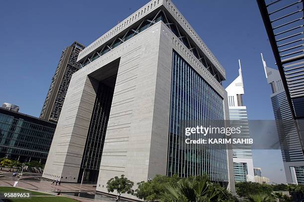 Men walk in front of the Dubai International Financial Center in the Gulf emirate on January 20, 2010. The total debt of cash-strapped Dubai could be...