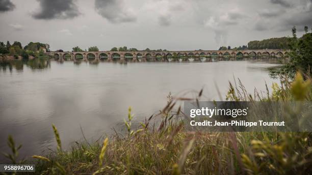 the loire river on a cloudy day, bridge of beaugency, france - loire valley spring stock pictures, royalty-free photos & images