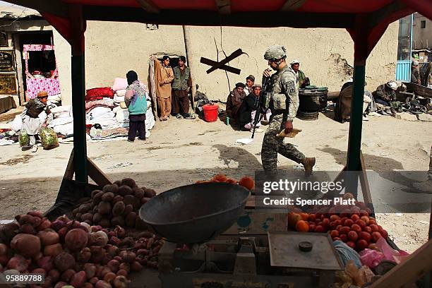 Army soldier from a Provincial Reconstruction Team walks through a market on January 20, 2010 in Orgune, Afghanistan. The soldiers, from Forward...