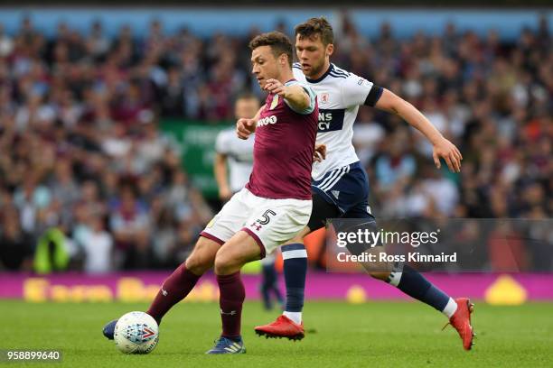 James Chester of Aston Villa controls the ball as Jonny Howson of Middlesbrough chases during the Sky Bet Championship Play Off Semi Final second leg...