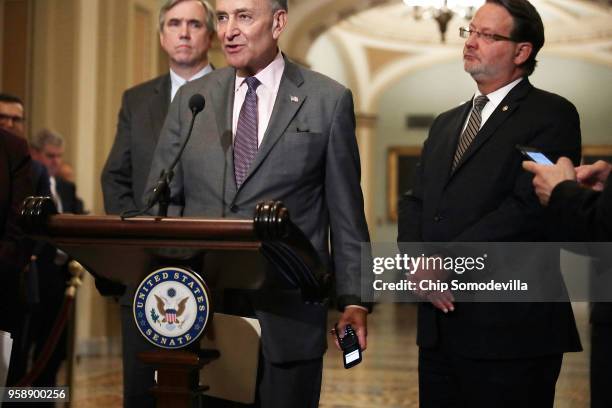 Senate Minority Leader Charles Schumer silences his flip phone after is started to ring while answering reporters' questions following the weekly...