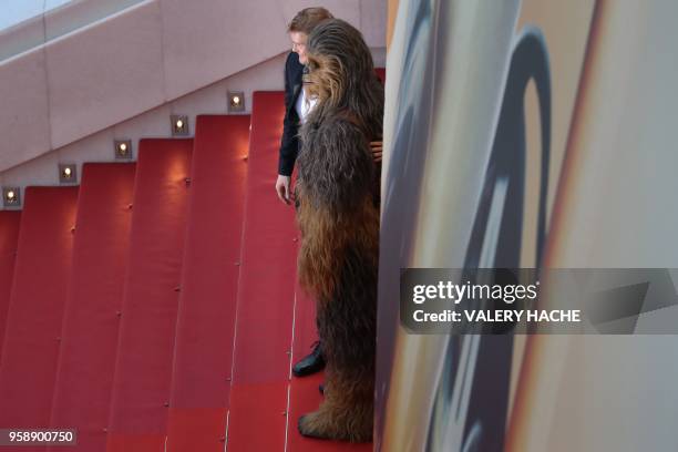 Finnish actor Joonas Suotamo and Chewbacca pose as they arrive on May 15, 2018 for the screening of the film "Solo : A Star Wars Story" at the 71st...