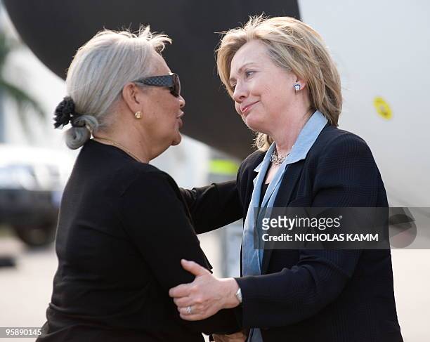 Secretary of State Hillary Clinton is greeted by Haitian Foreign Minister Marie-Michelle Rey as she arrives at Port-au-Proince Toussaint Louverture...