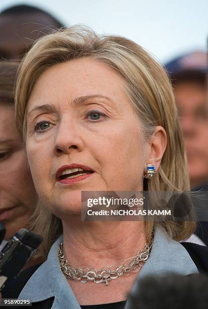 Secretary of State Hillary Clinton speaks to the press after meeting with Haitian President Rene Preval at Port-au-Prince's Toussaint Louverture...