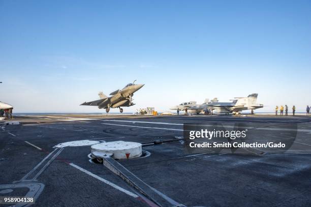 Rafale Marine French airplane landing aboard the aircraft carrier USS George HW Bush at the Atlantic Ocean, May 10, 2018. Image courtesy Petty...
