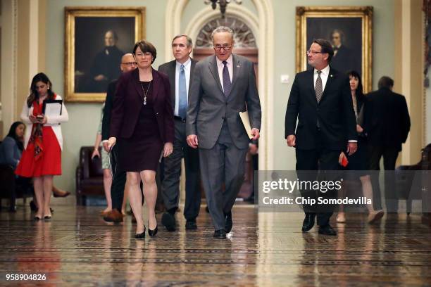 Sen. Amy Klbuchar , Sen. Jeff Merkley , Senate Minority Leader Charles Schumer and Sen. Greg Peters prepare to talk to reporters following the weekly...