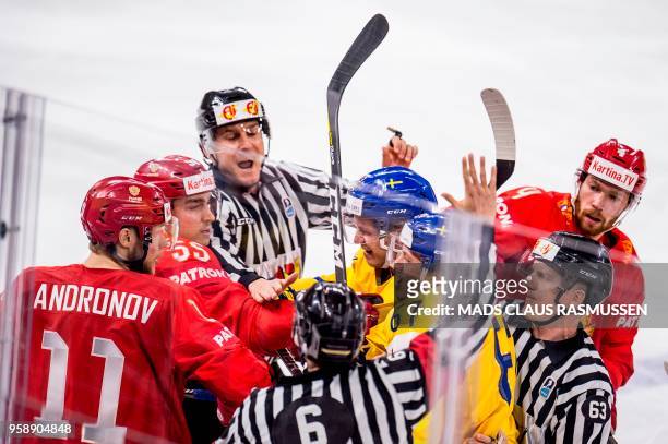 The referees seperate players during the group A match Russia v Sweden of the 2018 IIHF Ice Hockey World Championship at the Royal Arena in...