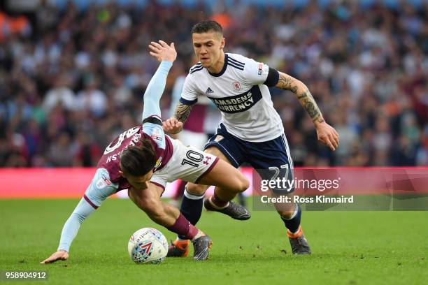 Jack Grealish of Aston Villa collides with Mo Besic of Middlesbrough during the Sky Bet Championship Play Off Semi Final second leg match between...