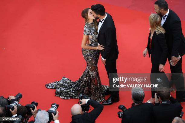 French-Swiss model Nabilla Benattia and her partner Thomas Vergara kiss as they arrive on May 15, 2018 for the screening of the film "Solo : A Star...