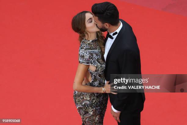 French-Swiss model Nabilla Benattia and her partner Thomas Vergara kiss as they arrive on May 15, 2018 for the screening of the film "Solo : A Star...