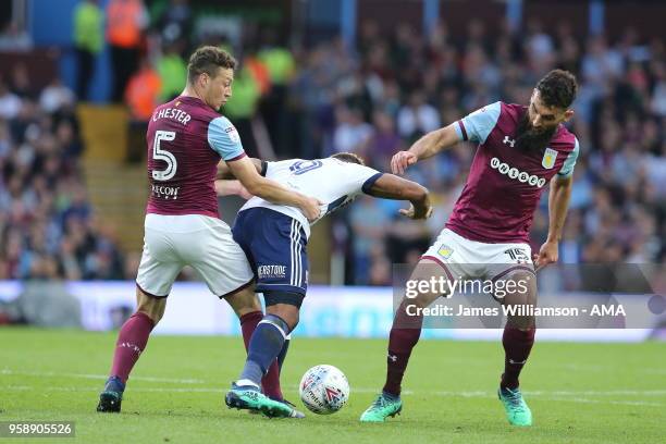 James Chester of Aston Villa and Britt Assombalonga of Middlesbrough and Mile Jedinak of Aston Villa during the Sky Bet Championship Play Off Semi...