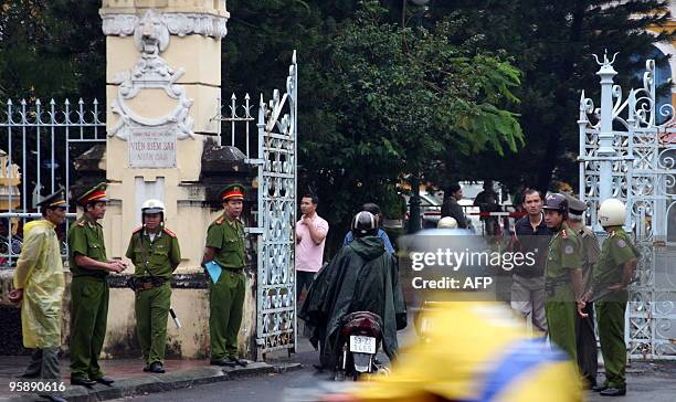 Policemen stand guard in front of Ho Chi Minh City People's Court House on January 20, 2010. The court sentenced a group of dissidents to up to 16...