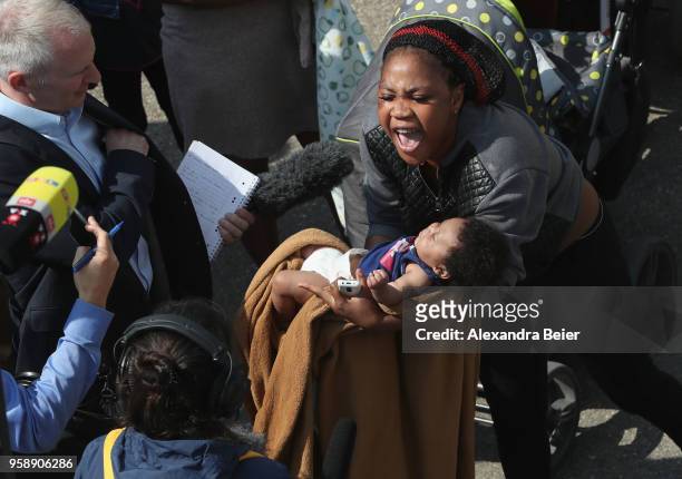 Resident holding her baby shouts out during a spontaneous protest at the Bavarian Transit Centre Manching/Ingolstadt for asylum-seekers on May 15,...