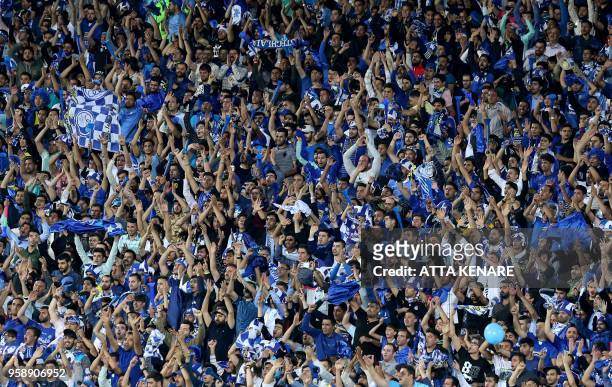 Iranian Esteghlal FC club fans cheer during their AFC Champions League football match Esteghlal vs Zobahan at the Azadi Stadium in Tehran on May 15,...