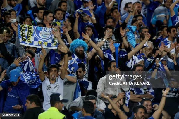 Iranian Esteghlal FC club fans cheer during their AFC Champions League football match Esteghlal vs Zobahan at the Azadi Stadium in Tehran on May 15,...