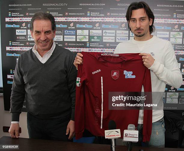 New Reggina Calcio player Luca Vigiani shows his new shirt with Reggina Calcio Team Manager Gianni Rosati before press conference at Sports Center...