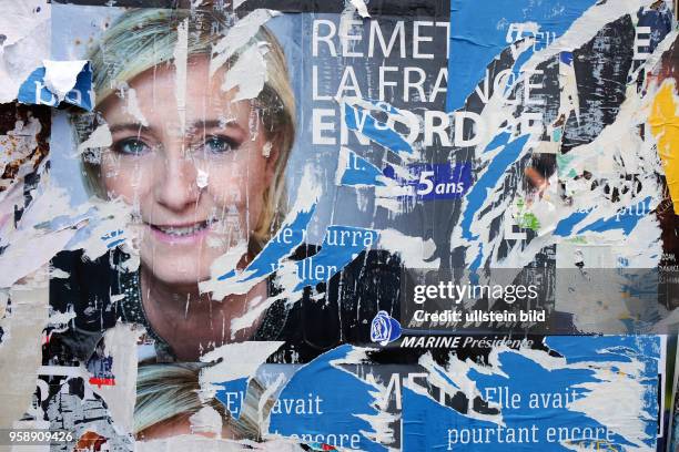 April 23, 2017 - Henin Beaumont, Nord, France. Far right candidate Marine le Pen?s poster is damaged by bystanders in Henin Beaumont. French...