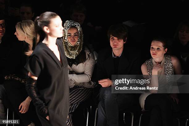 Model walks the runway while Eva Padberg , Aura Dione and Karoline Herfurth watch at the Schumacher Fashion Show during the Mercedes-Benz Fashion...