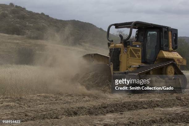 Fire D6N XL bulldozer excavating fire breaks during joint operations on Camp Pendleton, California, April 30, 2018. Image courtesy Pfc. Drake Nickels...