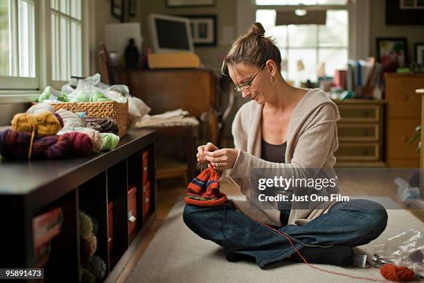 knitting a colorful hat at home. - maplewood stock pictures, royalty-free photos & images