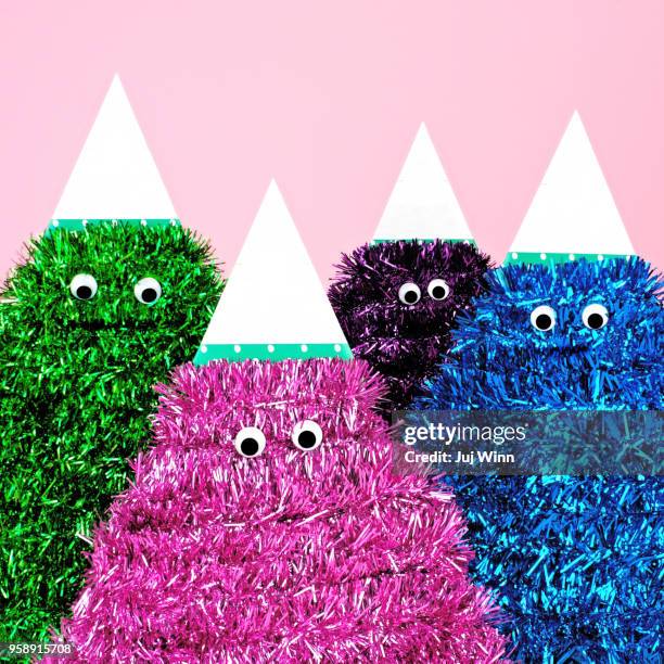 colorful tinsel characters with google eyes - lametta stock-fotos und bilder