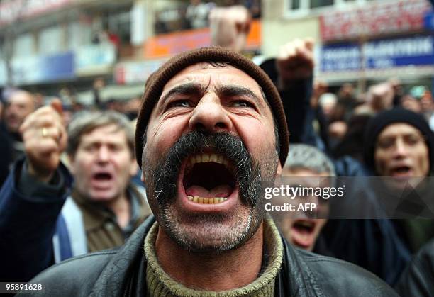 Turkish worker of the state tobacco company Tekel shouts anti-government slogans with other workers on the 32nd day of their protest in Ankara on...