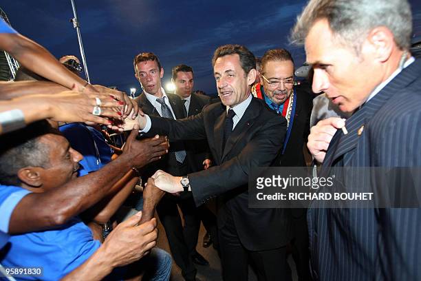French president Nicolas Sarkozy is welcomed on January 18, 2010 upon is arrival at the Pierrefonds airport on the French island of La Reunion. After...