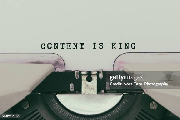 content is king text typed on vintage typewriter - word stock-fotos und bilder