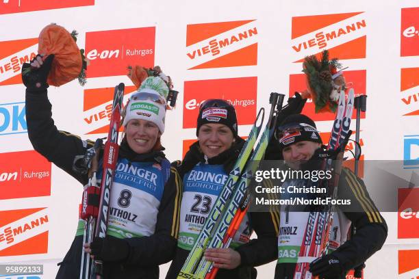 Kati Wilhelm of Germany , Magdalena Neuner of Germany and Andrea Henkel of Germany celebrate at the flower ceremony after the women's individual in...