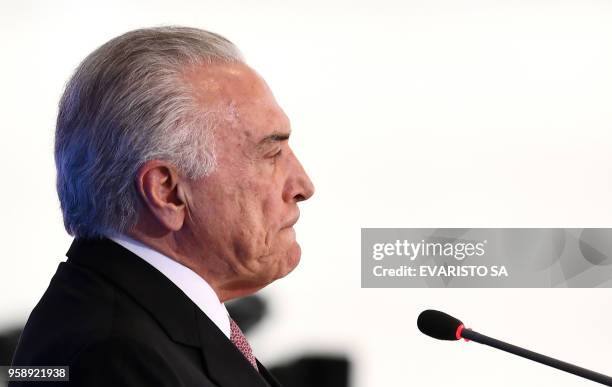 Brazilian President Michel Temer gestures during a ceremony celebrating two years in government at the Planalto Palace in Brasilia on May 15, 2018.