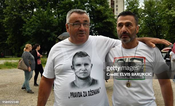 Two men wear t-shirts with the victims portraits and names as citizens of Sarajevo and Banja Luka gather in a joint protest in Sarajevo on May 15...