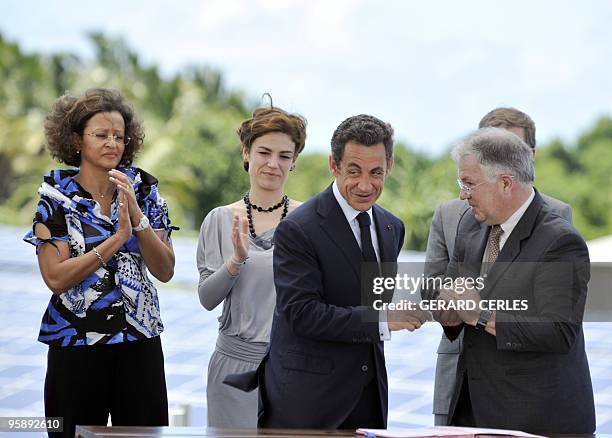 French President Nicolas Sarkozy arrives with Overseas Territories Minister Marie-Luce Penchard and Junior Minister for Ecology Chantal Jouanno to...