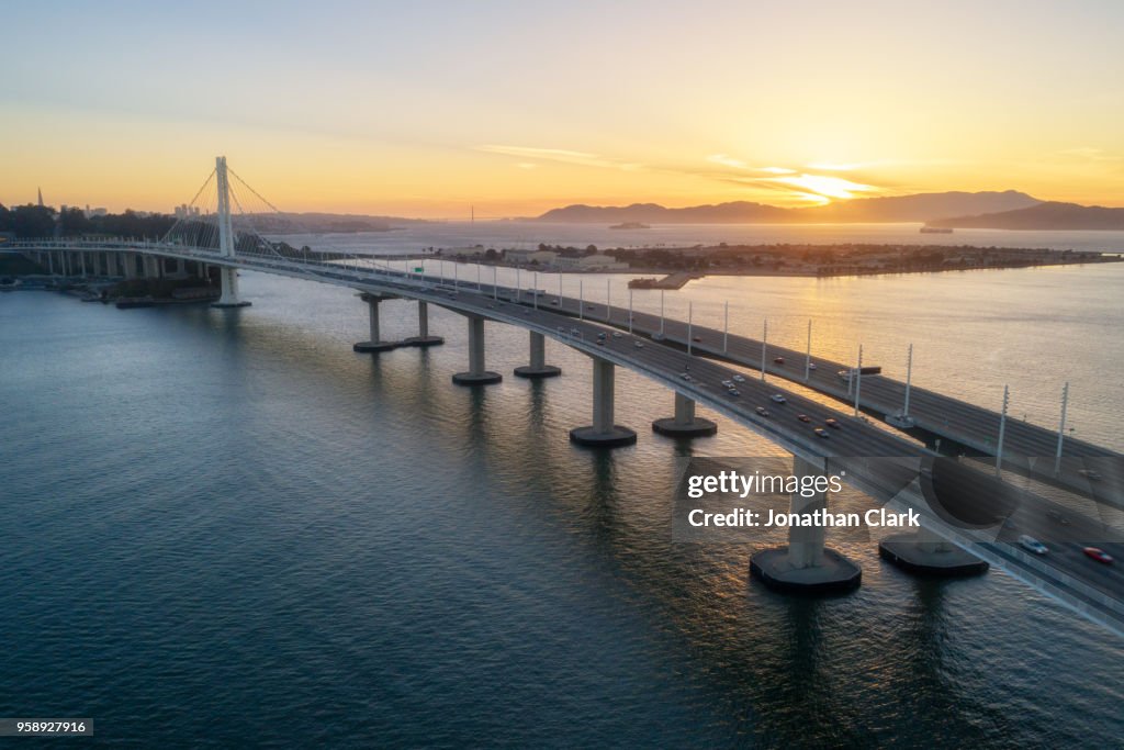 Aerial over traffic Bay Bridge at sunset, San Francisco, USA