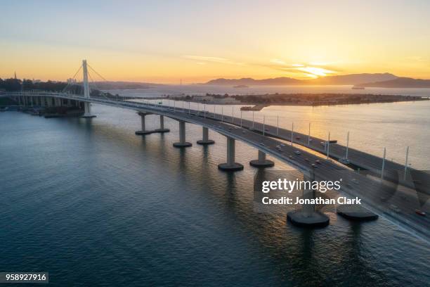 aerial over traffic bay bridge at sunset, san francisco, usa - jonathan clark stock pictures, royalty-free photos & images