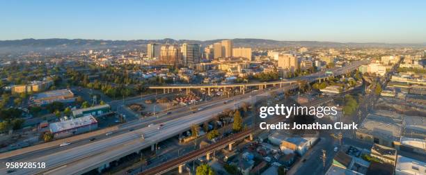 aerial: oakland city skyline at sunset. california, usa - jonathan clark stock pictures, royalty-free photos & images