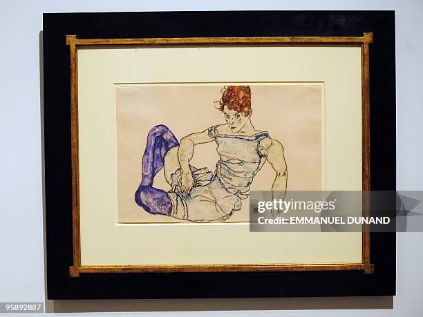 "Sitzen Frau mit violetten Strumpfen", a painting by artist Egon Schiele, is on display at Sotheby's during a preview at Sotheby's, January 20 in New...