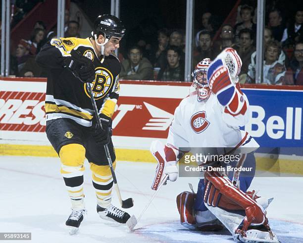 Goaltender Patrick Roy of the Montreal Canadiens protects the net against Kevin Stevens of the Boston Bruins in the 1995-1996 season at the Montreal...
