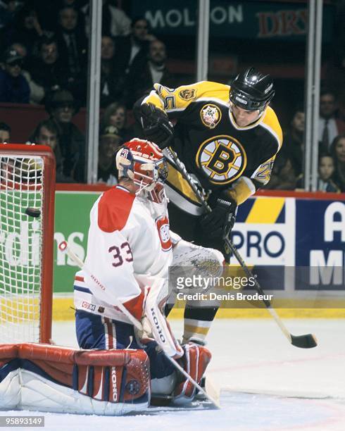 Kevin Stevens of the Boston Bruins takes a shot on goaltender Patrick Roy of the Montreal Canadiens in the 1995-1996 season at the Montreal Forum in...