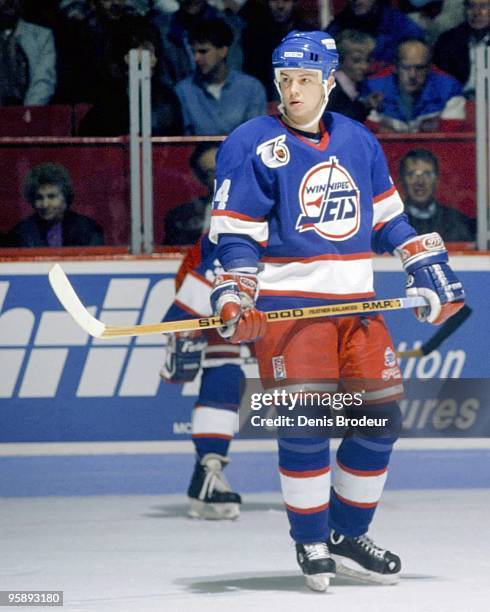 Stu Barnes of the Winnipeg Jets looks for the puck against the Montreal Canadiens in the early 1990's at the Montreal Forum in Montreal, Quebec,...