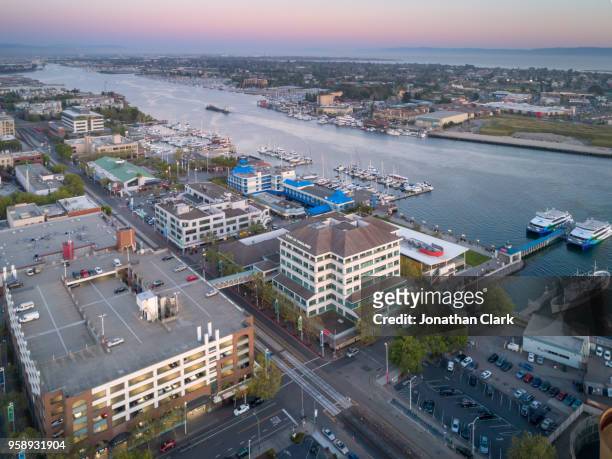 aerial: oakland city skyline over jack london square at sunset. california, usa - jonathan clark stock pictures, royalty-free photos & images