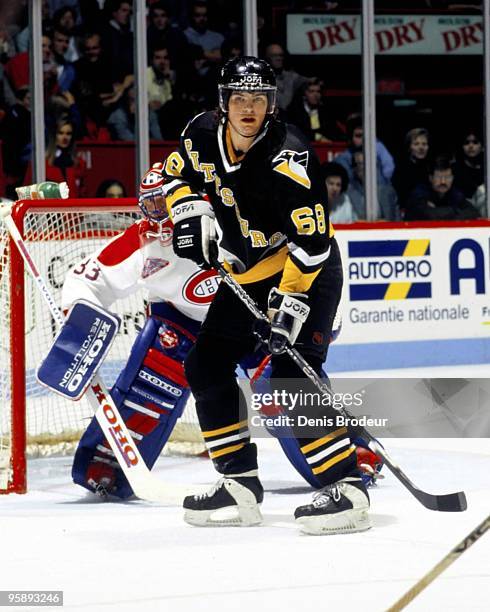 Jaromir Jagr of the Pittsburgh Penguins positions himself in front of the net as Goaltender Patrick Roy of the Montreal Canadiens protects the net in...