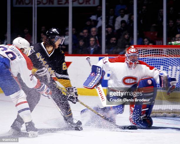 Goaltender Patrick Roy and Eric Desjardins of the Montreal Canadiens defends the net against Jaromir Jagr of the Pittsburgh Penguins in the early...