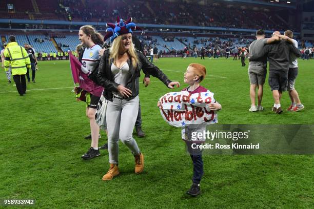 Young Aston Villa fan holds up a sign reading 'Road To Wembley' during the pitch invasion after the Sky Bet Championship Play Off Semi Final second...