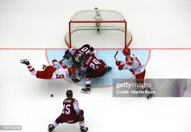 Elvis Merzlikins, goaltender of Latvia tends net against Philip Larsen of Denmark during the 2018 IIHF Ice Hockey World Championship Group B game...