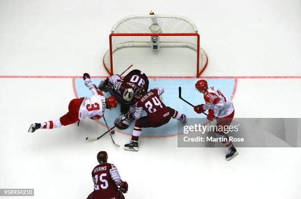 Elvis Merzlikins, goaltender of Latvia tends net against Philip Larsen of Denmark during the 2018 IIHF Ice Hockey World Championship Group B game...