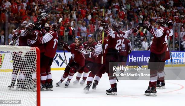 The team of Latvia celebrate victory over Denmark after the 2018 IIHF Ice Hockey World Championship Group B game between Latvia and Denmark at Jyske...